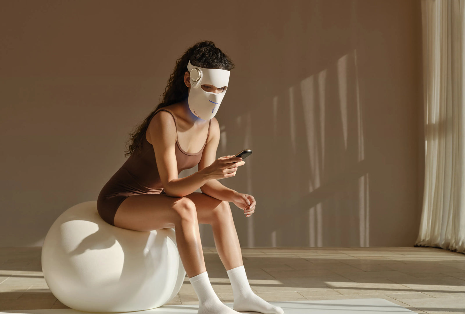 Dreame Chrona Photonen-Hautpflegemaske – Lichttherapie ohne Unterbrechung, auch beim Scrollen auf dem Smartphone.